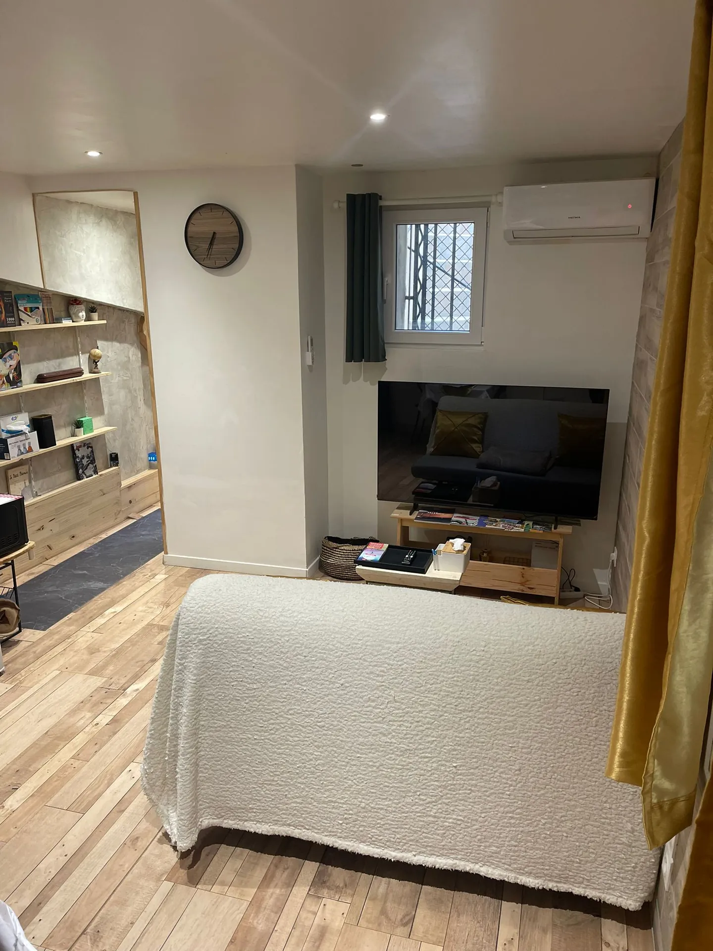Salon avec canapé-lit, télévision et climatisation